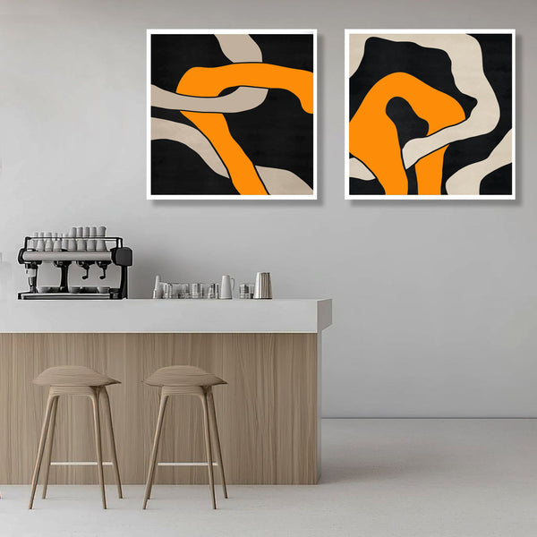 Two abstract art pieces on a wall above a counter with stools.