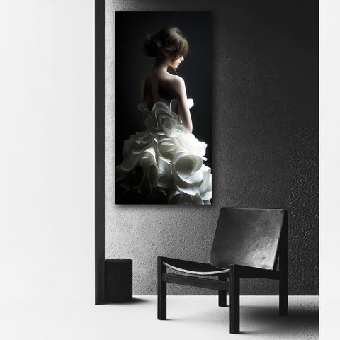 Framed black and white art print of a woman in a white dress on a dark background, leaning against a textured wall with a chair in front.